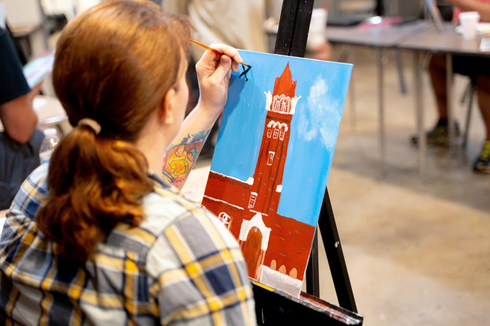 Female student veteran painting a canvas